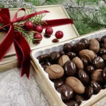 Holiday gift tin filled with chocolate covered Montmorency cherries and chocolate Almonds