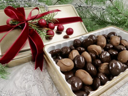 Holiday gift tin filled with chocolate covered Montmorency cherries and chocolate Almonds